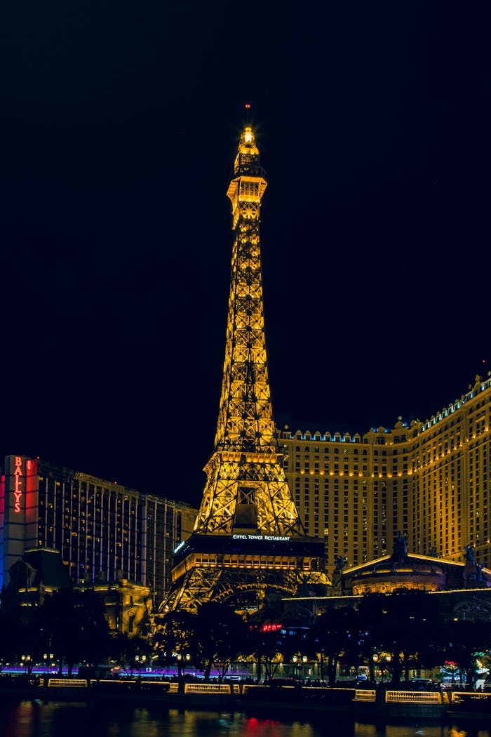 Illuminated Eiffel Tower replica at Paris Las Vegas Hotel at night.